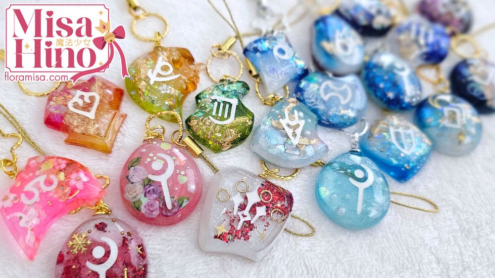 Various custom themed Final Fantasy XIV resin job stones arranged in rainbow order.