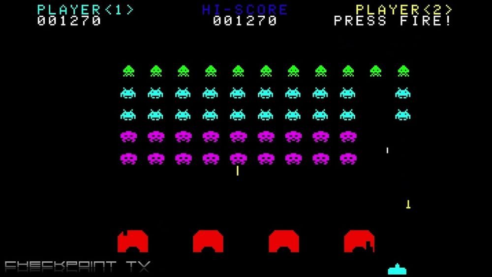 Screenshot from Atari's Space Invaders. Above the rows of the Invaders to be shot & they're shooting down at "you". Below, "you" shooting up at the buggers, with a row of damage-taking obstacles to hide behind when shit gets real