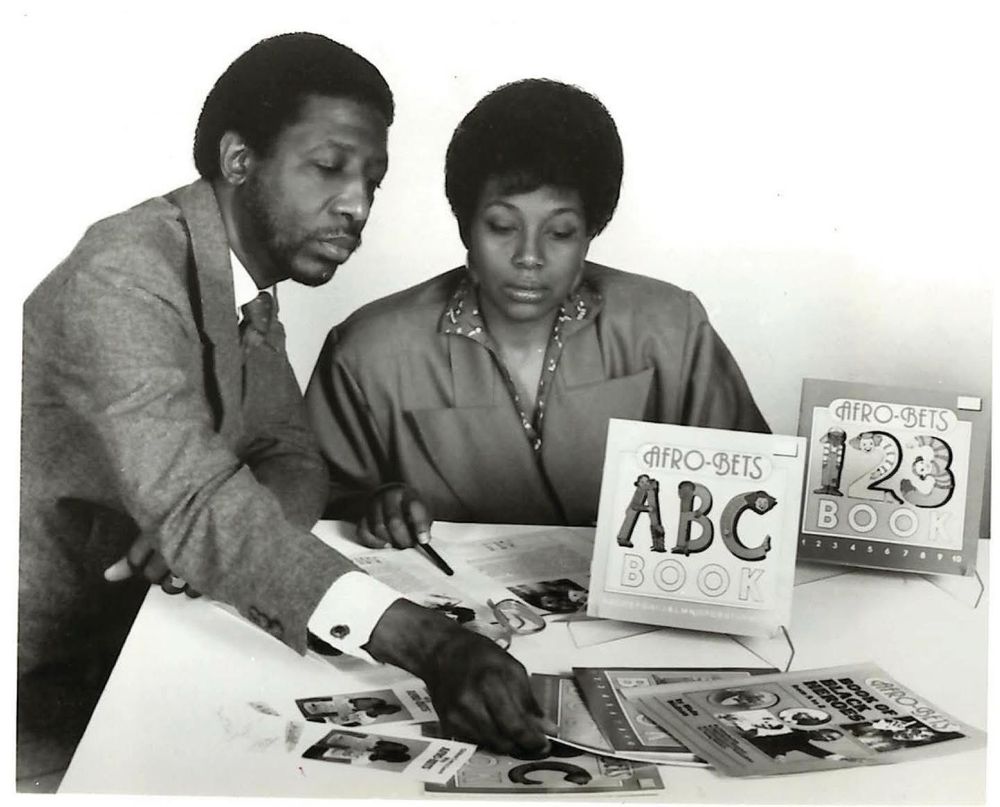 A black and white photo of the Hudsons during a 1989 product shot for their new books
