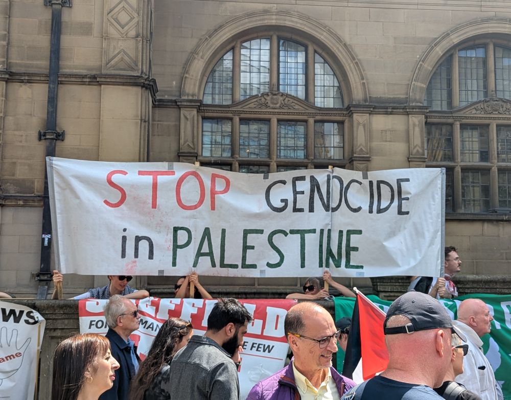Sign reads "Stop genocide in Palestine"