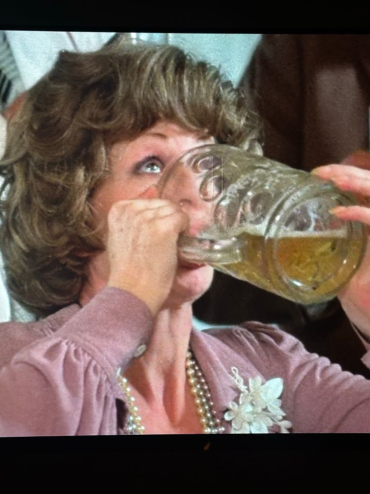 Woman drinking beer from large beer glass in Cousin Cousine, the film.