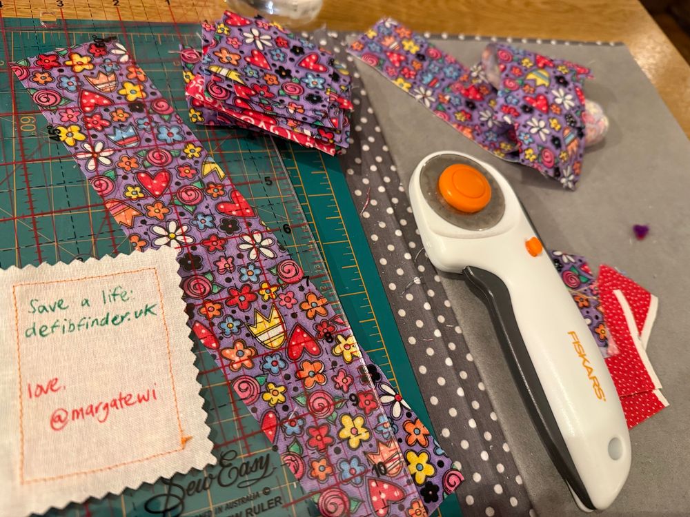 Strips of fabric being cut down to size for the stamps