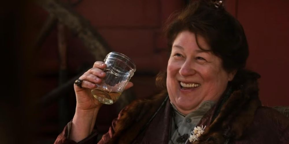 Margo martindale from justified smiling and holding a glass