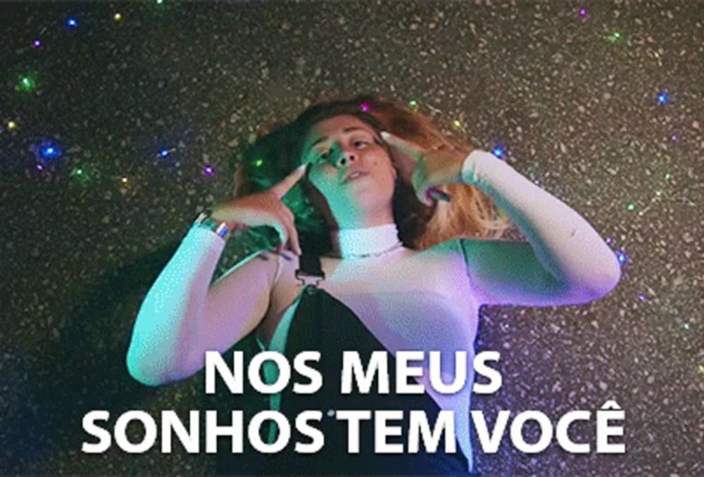 a woman with nos meus sonhos tem voce written in white