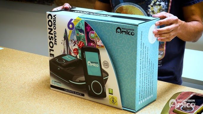 A screenshot of an Intellivision Amico in the box and being held on a desk. 