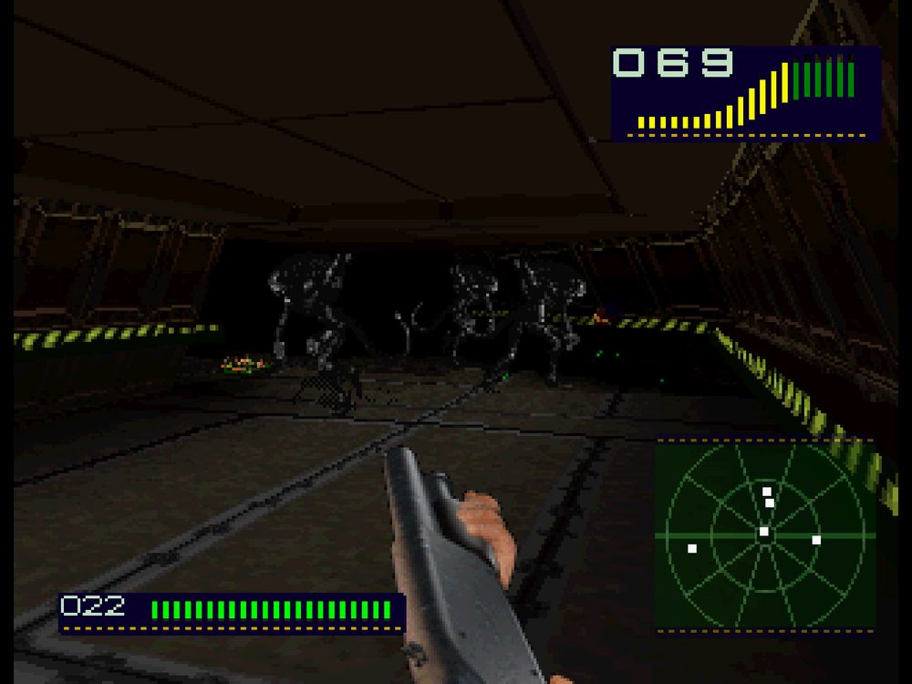 A screenshot of Alien Trilogy. It shows the player, who views the game from the first-perspective, holding a shotgun and aiming and shooting it at three to four aliens in front of them. 