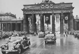 Image of Adolf Hitler passing through the Brandenburg Gate on his way to the opening ceremonies of the 1936 Olympic Games 