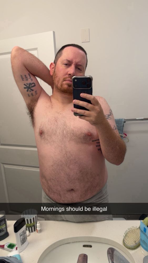 Me in a towel post-shower with my left arm raised, hand behind head. The shower counter can be seen and the words “mornings should be illegal” is overlayed on the photo. 