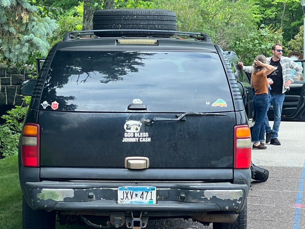 Black SUV with “God Bless Johnny Cash” sticker on the back