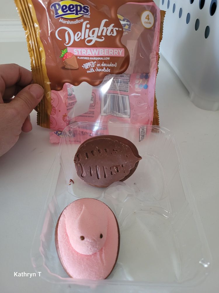 Two Delights Strawberry Peeps are shown in front of the packaging. One of them is on its side showing the chocolate bottom.