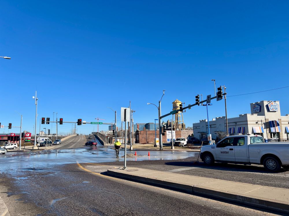 Manchester and Vandeventer Avenues where water is bubbling up out of the road and a Water Division truck is on site. 