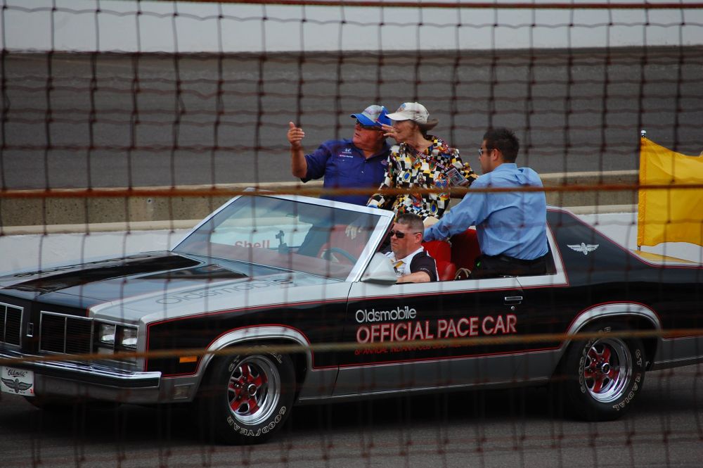 AJ Foyt and Mari Hulman George, both in their late 70's, in a pace car from the late 70's.
