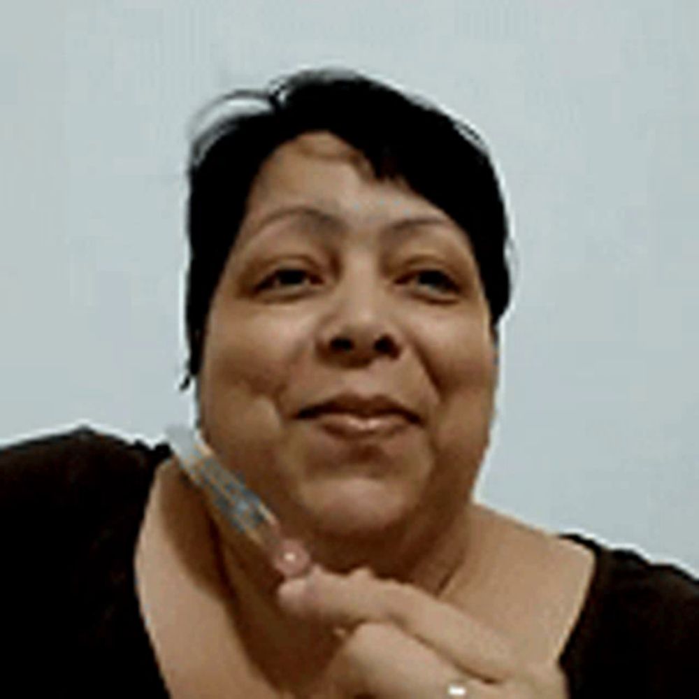 a close up of a woman 's face with a toothbrush in her hand .