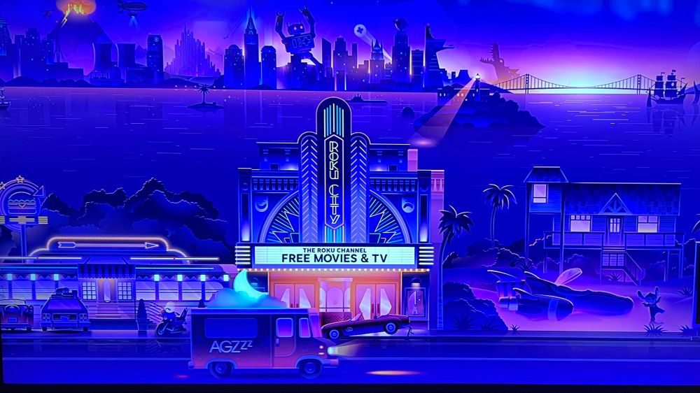 A truck similar looking to an ice cream truck with AGZzz on it drives thru Roku City screensaver 