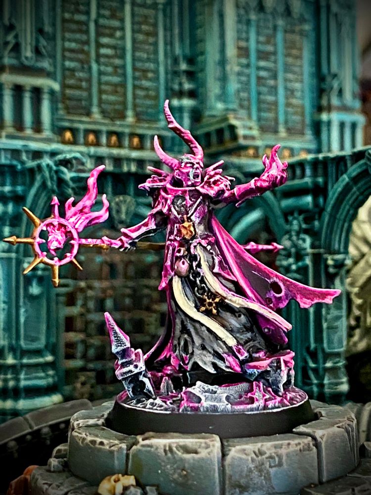 Horned chaos magic user burning hot pink magic fires from his staff and hand while screaming insults at foes and bystanders. 
He’s called Jeff and used to work in correspondence but doesn’t want people to know that. 