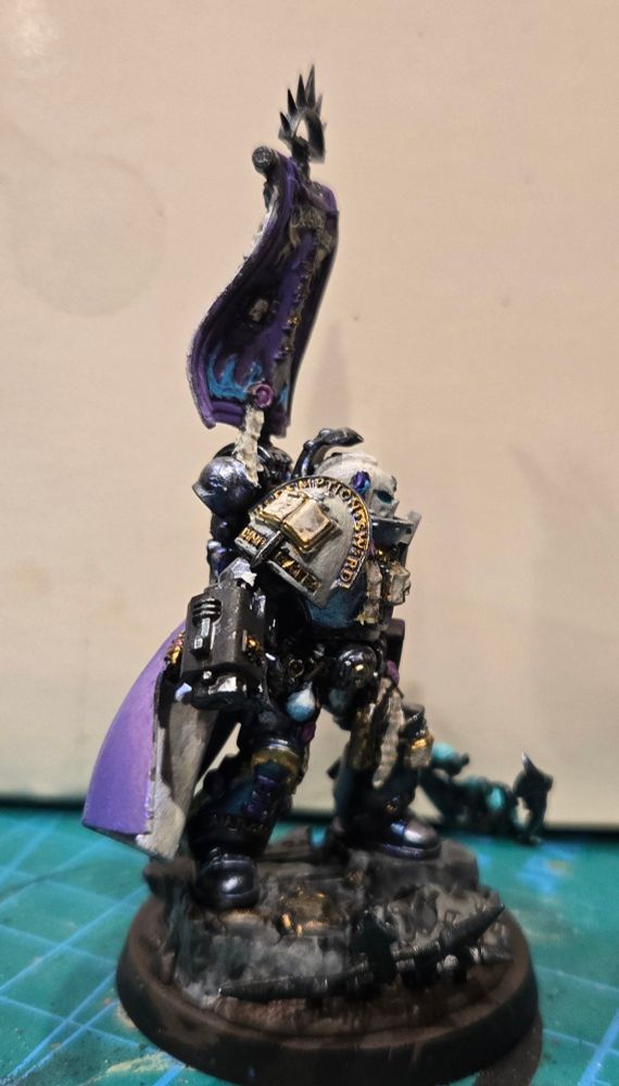 Castellan Crowe in a very fine Purple silken cape with his famous seafoam flaming demon sword. His silver armor has a purple/blue shimmer and his white helmet and shoulders have a pearlescent sheen.