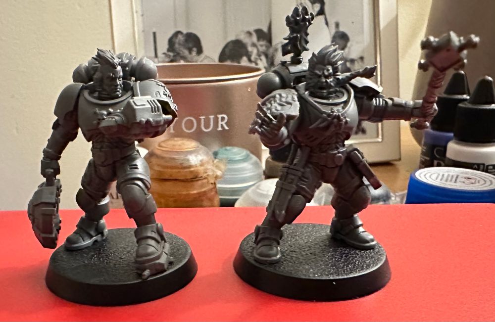 Trapmaster and rune priest skjald space wolf scouts.

The trapmaster is carrying a big bomb and is checking the readout on a screen on his wrist.

The rune priest has an arm outstretched and the other is brandishing a staff.