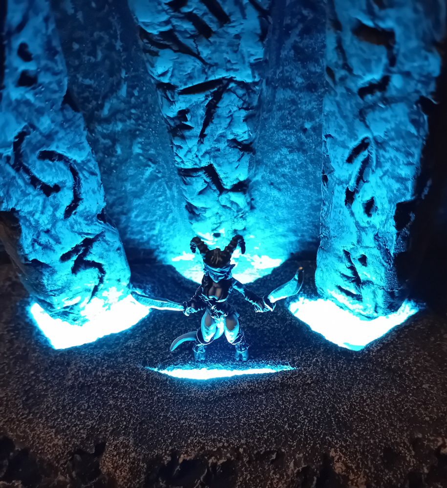Seen from above, and in starker contrast, we see Keynsey between the stones, a split in the floor just in front of her little hooveses, spitting blue magical fire from the depths of Hell itself. The same intensely bright blue light is seen tearing through the ground behind her, the ritual stones brightly lit from beneath.