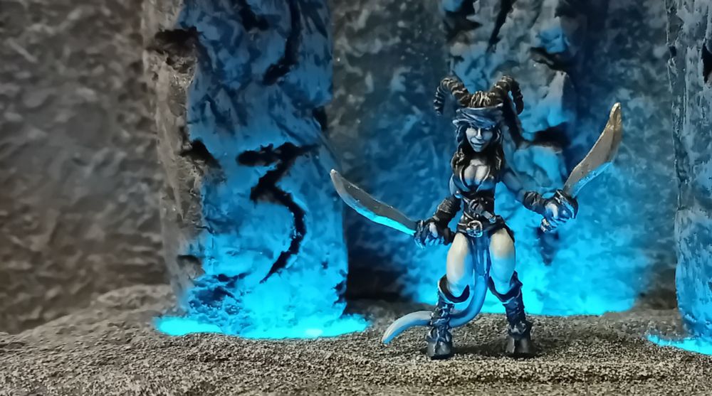 Keynsey is standing slightly to the right and we can clearly see the rents in the ground behind her. Bright blue light and magic is pouring through, lighting the ritual stones and Keynsey is having a great day, thanks for asking.
