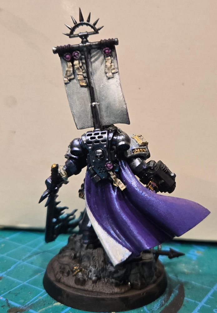 Castellan Crowe in a very fine Purple silken cape with his famous seafoam flaming demon sword. His silver armor has a purple/blue shimmer and his white helmet and shoulders have a pearlescent sheen.