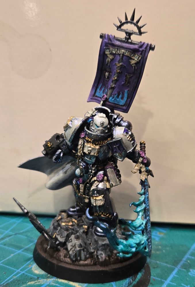 Castellan Crowe in a very fine Purple silken cape with his famous seafoam flaming demon sword. His silver armor has a purple/blue shimmer and his white helmet and shoulders have a pearlescent sheen.