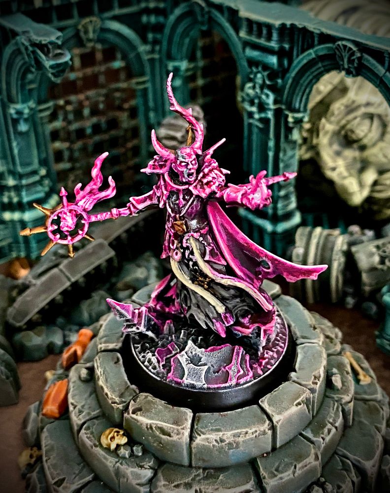 Horned chaos magic user burning hot pink magic fires from his staff and hand while screaming insults at foes and bystanders. 
He’s called Jeff and used to work in correspondence but doesn’t want people to know that. 