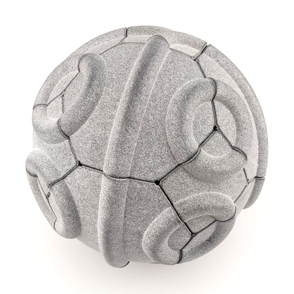 Spherical Truchet tiling of a truncated octahedron made of speckled gray plastic