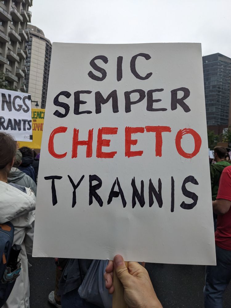 Hand written protest sign that says "SIC SEMPER CHEETO TYRANNIS"