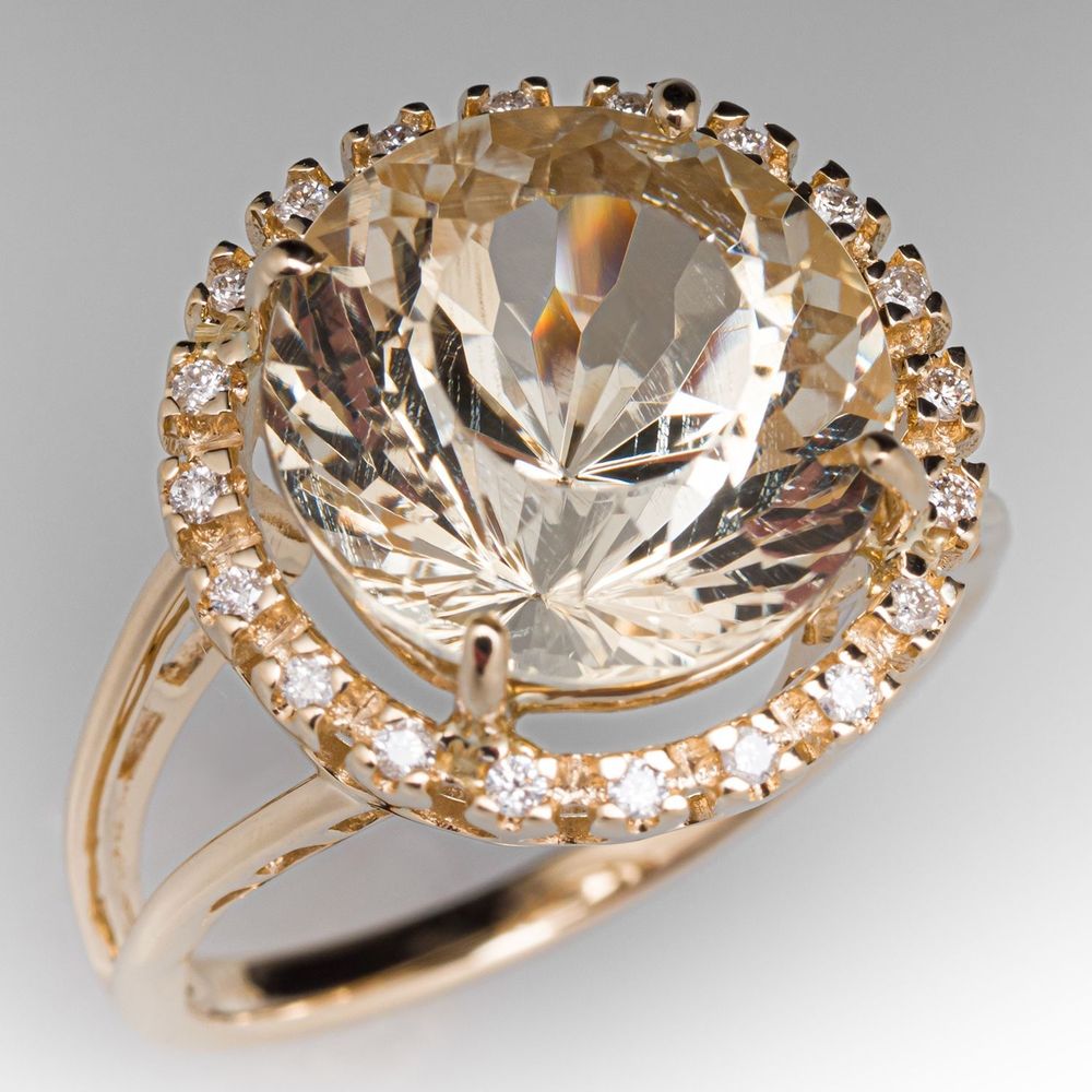 7-carat sunstone cocktail ring listed on my favorite wishing site, eragem. It's a translucent feldspar mineral with a glittery effect called "aventurescence," formed in lava. You wouldn't mistake it for a diamond, but it doesn't look like crystal or glass either; it is very much its own thing. This ring is in yellow gold, which complements the stone nicely, and has a ring of small diamonds around the large sunstone.