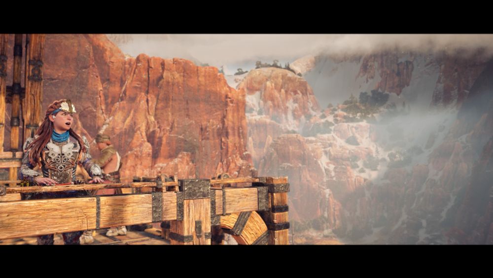 Aloy watches in wonder as she takes the cable car down into the Daunt. 