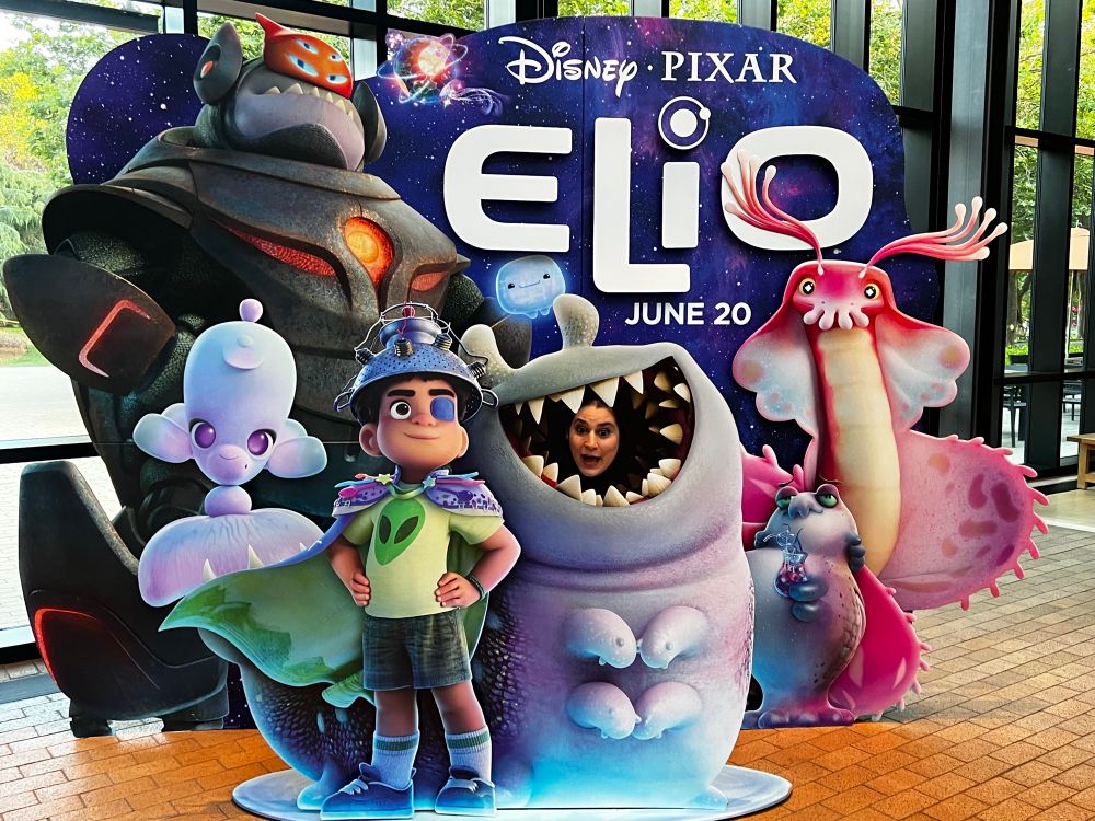 Whacky lady being eaten by adorable alien.