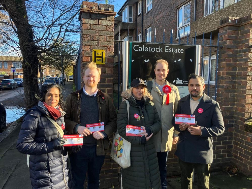 Labour candidate Erik (centre-right) with fellow candidate and current councillor Majid Rahman (right) and Labour activists, including Councillor Rowshan Hannan (left), in front of a sign reading 'Caletock Estate'.