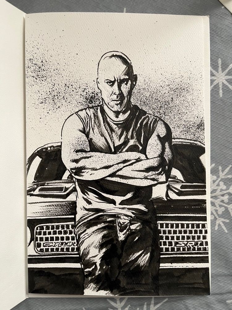 Vin Diesel standing in front of a Dodge Challenger