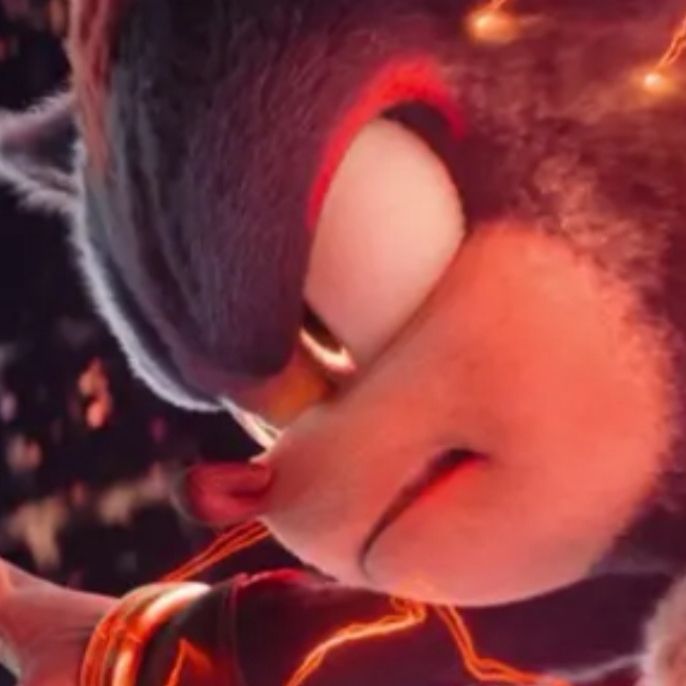 Sonic the Hedgehog 3, Film, screenshot. Close up on Shadow the Hedgehog. He grimaces intently. But he's also a cute fuzzy lil guy. So tufty. With a cute little nose. 