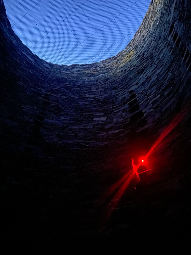Inside Mousa broch. A red light is used to illuminate the inner staircase so as to not disturb storm petrels.