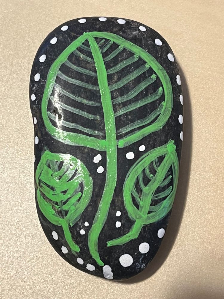 black stone with green leaves and white dots