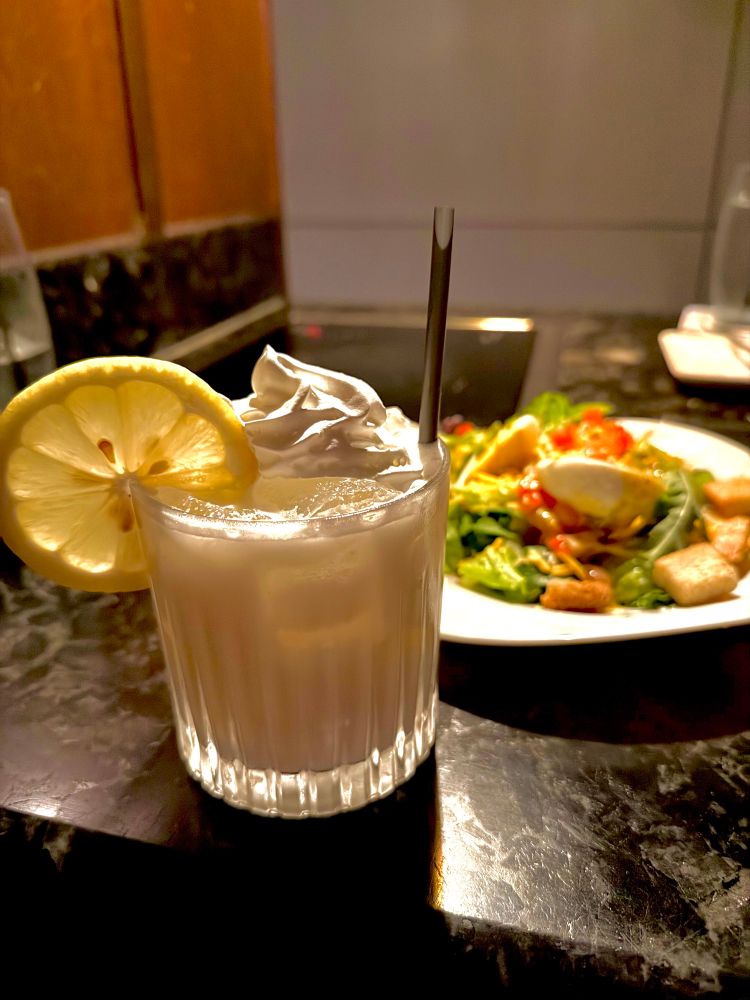 Whipped Sunshine Lemonade

Tito's Handmade Vodka, Caravella Limoncello Liqueur, ice cream, agave, lemon juice, and whipped cream.

A salad behind it.
