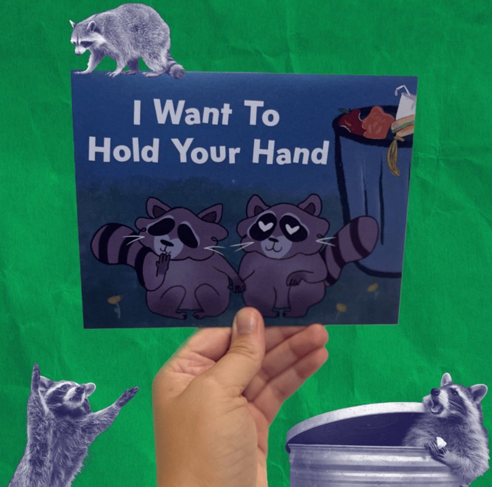 Greeting card that reads “I want ti hold your hand” featuring two raccoons holding hands next to a trash can 