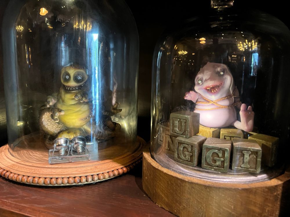 Two little blob critters in glass jars in Dark Universe.