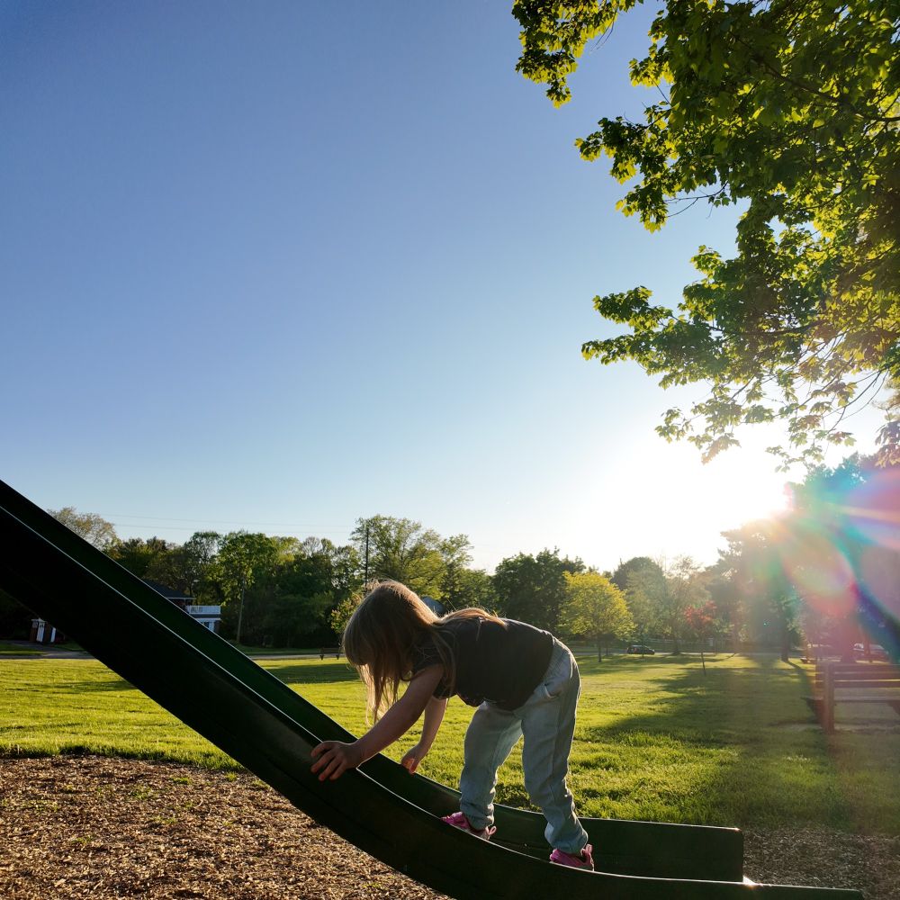 My daughter climbing up a slide. 