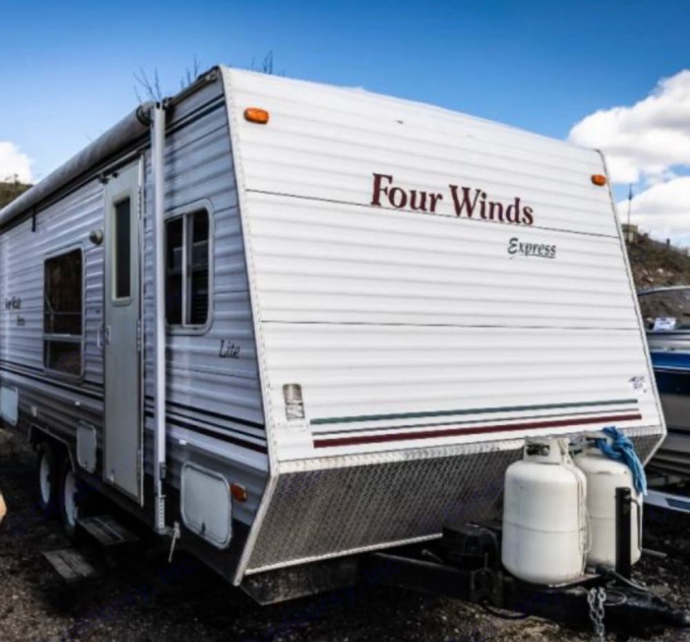 Photo of a camper trailer with the Four Winds logo on the front