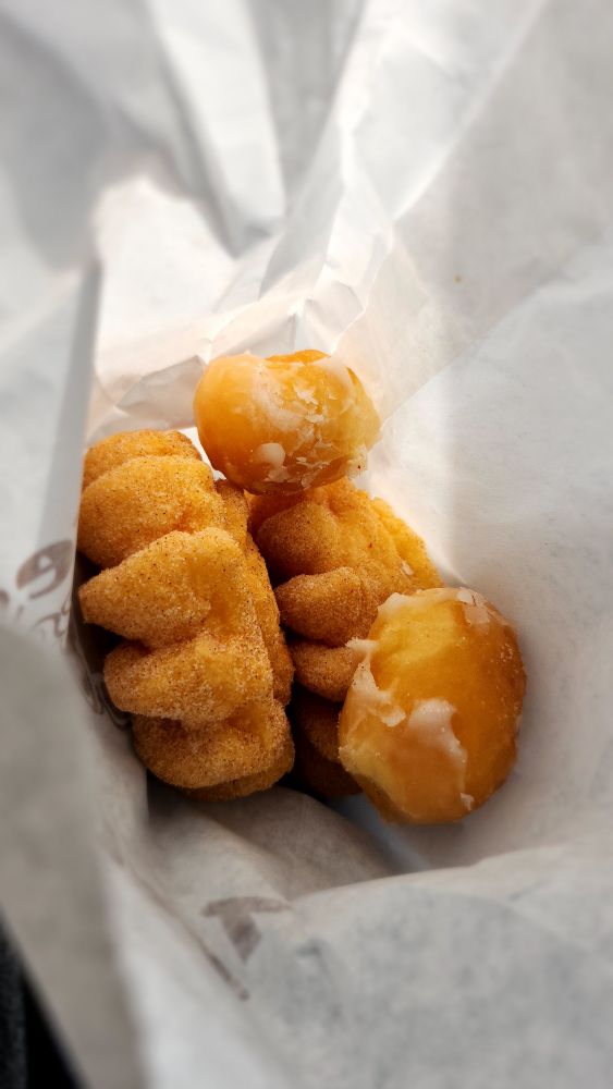 Two cinnamon sugar french crullers, and two bonus glazed donut holes