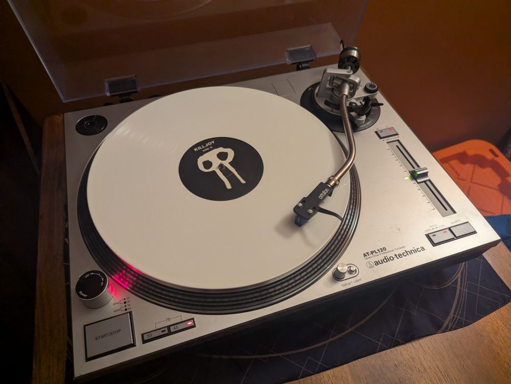 A white vinyl record of Fox Stevenson's album "Killjoy" being played on an AT PL120 turntable 