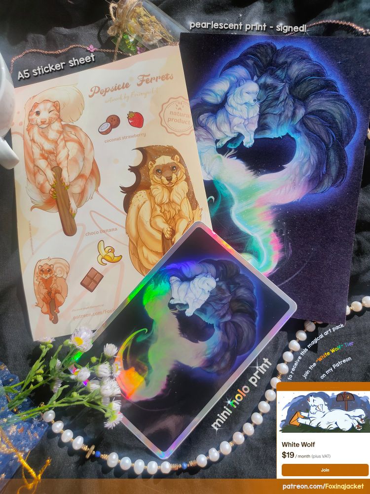 A flat-lay photo of a Patreon art reward pack, displayed on a black velvet cloth with pearls and white wildflowers. The pack includes an A5 sticker sheet titled “Popsicle Ferrets” featuring cute ferrets shaped like popsicles, a signed A5 pearlescent print of two Kitsunes curled together in glowing aurora colours, and a small holographic A6 print of the same artwork. Soft sunlight highlights the shimmer and holographic effects. Decorative text on the image reads: “to receive this magical art pack join the "White Wolf" Tier on my Patreon". And the link below: patreon.com/Foxinajacket