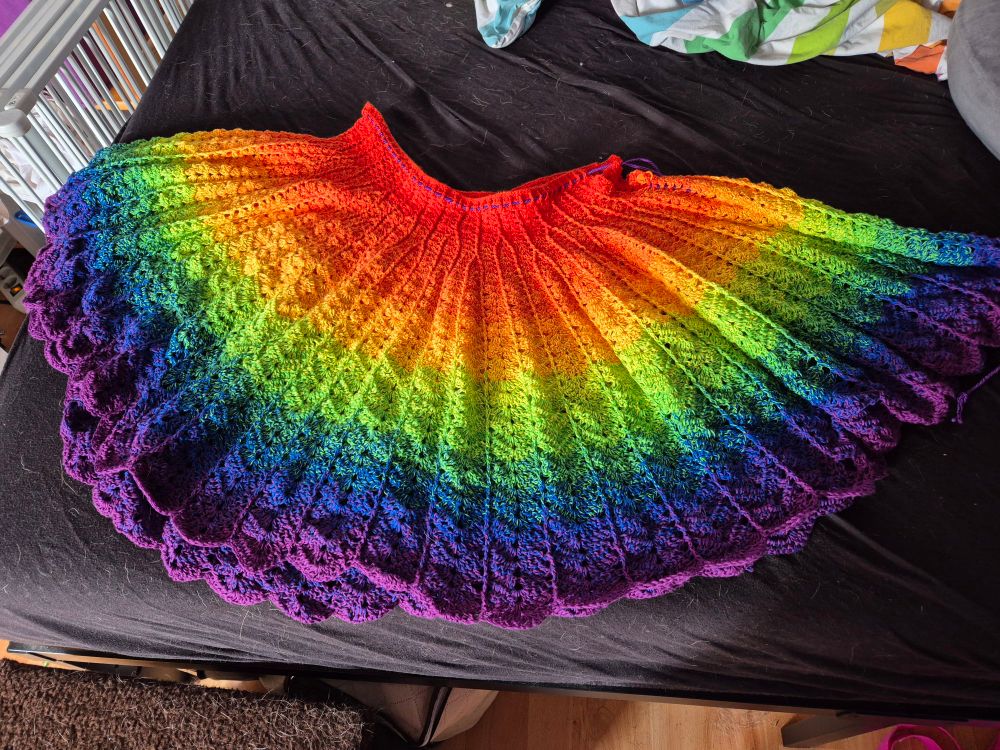 Photo of a crochet skirt in rainbow colors. 