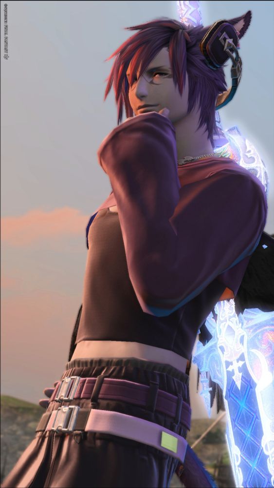 A screenshot of a player character from Final Fantasy 14. He is wearing a more modern purple and black sweater with black sports pants and purple belts. He also has a bright blue sword and a pair of headphones.
In my post i describe this as an outfit that is 'just for fun' compared to a 'canon' outfit.
