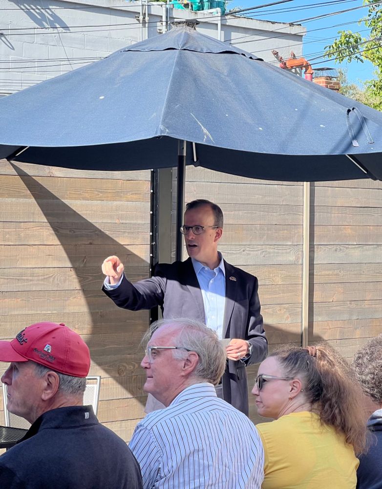 Assemblymember Berman is pointing to someone in the crowd. 