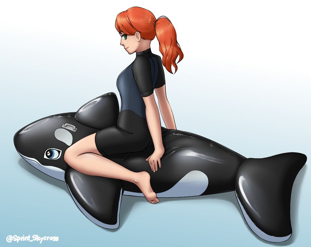 Red-head woman in a wetsuit, sitting on top of a large inflatable orca pool toy. 