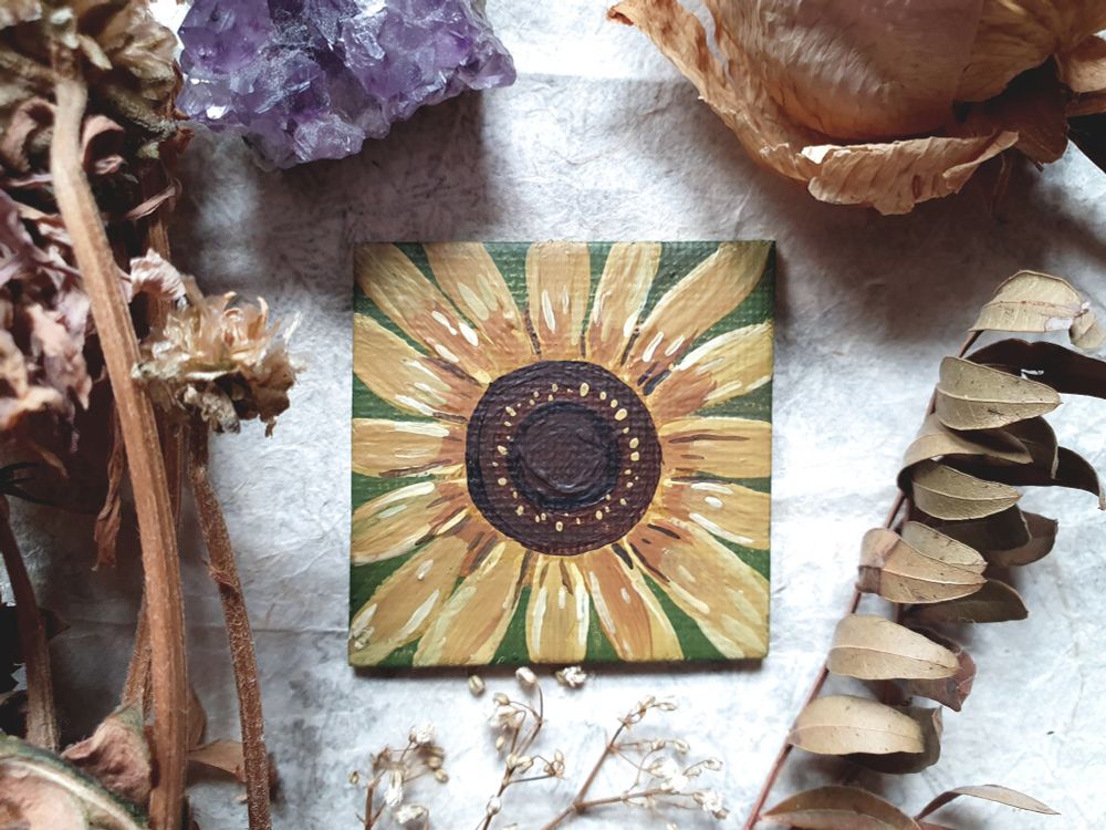 Photo of a gouache painting of a sunflower head.
