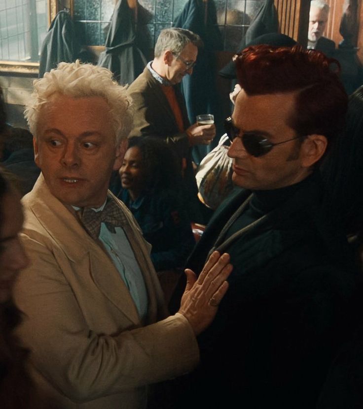 Aziraphale putting his hand on the chest of the thin dark Duke 